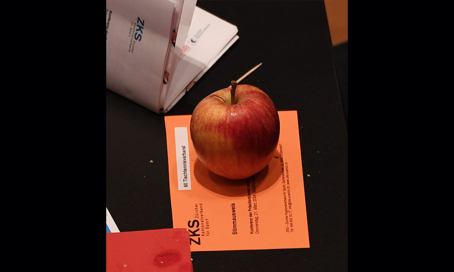 Gesunde Verpflegung: Ein Apfel liegt auf einem Stimmausweis. 